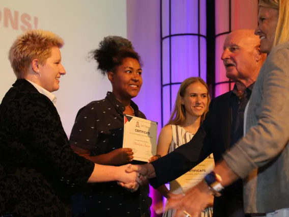 Award recipients shaking hands on stage