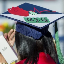 Back of a graduate's mortarboard cap with customized artwork of a heart and lettering